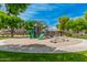 Community playground with slides, climbing structures, and swings, perfect for recreation at 43615 W Roth Rd, Maricopa, AZ 85138