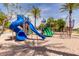 Large community playground with a variety of colorful slides and climbing structures set in a sandy play area at 43615 W Roth Rd, Maricopa, AZ 85138