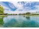 Scenic pond with lush green landscaping and mature trees, providing a peaceful and serene environment at 43615 W Roth Rd, Maricopa, AZ 85138