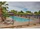 Community pool surrounded by palm trees and lounge chairs, offering a refreshing escape on warm days at 43615 W Roth Rd, Maricopa, AZ 85138