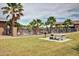 Community pool with palm trees and a picnic area provides a refreshing escape for residents on sunny days at 43615 W Roth Rd, Maricopa, AZ 85138