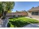 Lush backyard with mature trees, green lawn, and lounge chairs offers a serene outdoor space at 4407 W Avenida Del Sol --, Glendale, AZ 85310