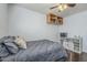 A well-lit bedroom with hardwood floors featuring a bed and a wooden shelving unit at 4407 W Avenida Del Sol --, Glendale, AZ 85310