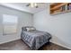 A neatly decorated bedroom with hardwood floors and a cozy bed setup at 4407 W Avenida Del Sol --, Glendale, AZ 85310