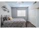 Inviting bedroom with cloud painted ceiling, hardwood floors, and a silver metal bed frame at 4407 W Avenida Del Sol --, Glendale, AZ 85310