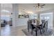 Open dining room featuring a ceiling fan, pendant lights, and views into the living room and kitchen at 4407 W Avenida Del Sol --, Glendale, AZ 85310