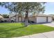 Attractive home exterior with a well-kept lawn, mature trees, and a spacious driveway at 4407 W Avenida Del Sol --, Glendale, AZ 85310