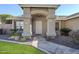Inviting front entrance with a decorative door, stone walkway, and lush landscaping at 4407 W Avenida Del Sol --, Glendale, AZ 85310