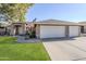 Charming single-story home with a three-car garage, well-maintained lawn, and an American flag at 4407 W Avenida Del Sol --, Glendale, AZ 85310
