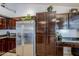 Well-designed kitchen featuring a stainless steel refrigerator, cabinets, and granite counters at 4407 W Avenida Del Sol --, Glendale, AZ 85310