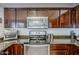 Modern kitchen features stainless steel appliances and beautiful dark wood cabinetry with stylish hardware at 4407 W Avenida Del Sol --, Glendale, AZ 85310