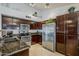 Modern kitchen featuring stainless steel appliances, granite countertops, and dark wood cabinetry at 4407 W Avenida Del Sol --, Glendale, AZ 85310