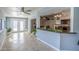 Bright living area with tile floors, leading to outdoor space through double doors, and kitchen pass-through at 4407 W Avenida Del Sol --, Glendale, AZ 85310
