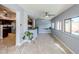 Spacious living area with many windows, neutral paint, and kitchen access featuring tile floors at 4407 W Avenida Del Sol --, Glendale, AZ 85310