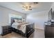 Well-lit main bedroom featuring dark wood floors, a ceiling fan, and stylish furnishings at 4407 W Avenida Del Sol --, Glendale, AZ 85310