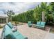 Inviting backyard patio featuring lounge seating, mature landscaping, and access to grassy lawn at 4443 W Acoma Dr, Glendale, AZ 85306