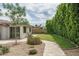 Expansive backyard featuring lush green lawn, mature trees, and a charming stone pathway, perfect for outdoor enjoyment at 4443 W Acoma Dr, Glendale, AZ 85306