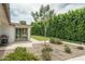Backyard patio with desert landscaping and access to the grassy lawn and outdoor grill at 4443 W Acoma Dr, Glendale, AZ 85306
