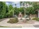 Entertaining backyard with custom fireplace and outdoor furniture set on a stone tile patio at 4443 W Acoma Dr, Glendale, AZ 85306