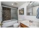 Well-lit bathroom with shower over tub, modern vanity, and stylish decor for a functional and updated space at 4443 W Acoma Dr, Glendale, AZ 85306