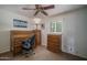 Comfortable bedroom featuring a desk, ceiling fan, natural light, and wood furnishings for a relaxing retreat at 4443 W Acoma Dr, Glendale, AZ 85306