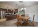Dining area adjacent to kitchen with a wood table, four chairs and a chandelier at 4443 W Acoma Dr, Glendale, AZ 85306