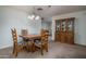 Inviting dining room with a wooden table set and a classic chandelier at 4443 W Acoma Dr, Glendale, AZ 85306