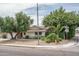 Charming home exterior with well-manicured landscaping, mature trees, and a welcoming curb appeal in a quiet neighborhood at 4443 W Acoma Dr, Glendale, AZ 85306