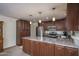 Modern kitchen with an island, stainless steel appliances, granite countertops, and ample cabinet space at 4443 W Acoma Dr, Glendale, AZ 85306
