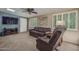 Bright living room with shutters, fan, skylight, and comfortable leather furniture at 4443 W Acoma Dr, Glendale, AZ 85306