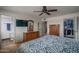 Bedroom featuring dresser, TV, closet, and adjacent bathroom at 4443 W Acoma Dr, Glendale, AZ 85306