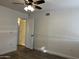 Bedroom featuring hardwood-style flooring, ceiling fan, neutral paint and door leading to en-suite bathroom at 461 W Holmes Ave # 271, Mesa, AZ 85210