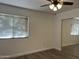 Well-lit bedroom featuring hardwood-style flooring, ceiling fan, window with blinds and mirrored closet at 461 W Holmes Ave # 271, Mesa, AZ 85210
