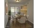 Dining room with seating for six near sliding glass door and view of kitchen at 461 W Holmes Ave # 271, Mesa, AZ 85210