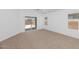 Bedroom boasts natural light, access to the backyard pool, and neutral carpet at 471 W Gascon Rd, San Tan Valley, AZ 85143
