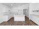 Bright kitchen features white cabinets, stainless steel sink, and an island at 471 W Gascon Rd, San Tan Valley, AZ 85143
