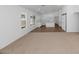 Well-lit living area with white walls and neutral carpet at 471 W Gascon Rd, San Tan Valley, AZ 85143