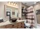 Bathroom with granite counters, wood cabinets, vessel sink, and a shower/tub combo at 500 N Roosevelt Ave # 26, Chandler, AZ 85226