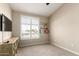 Small bedroom or office features carpet, plantation shutters and a TV at 500 N Roosevelt Ave # 26, Chandler, AZ 85226