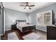 This bedroom features a dark wood bed frame, gray walls and plantation shutters at 500 N Roosevelt Ave # 26, Chandler, AZ 85226