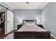 This bedroom features a dark wood bed frame, gray walls and a sliding closet door at 500 N Roosevelt Ave # 26, Chandler, AZ 85226
