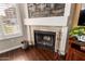 Close up of the fireplace featuring a stone surround, mantel with wooden planking and wood floors at 500 N Roosevelt Ave # 26, Chandler, AZ 85226