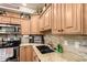 A bright kitchen with natural wood cabinets and updated fixtures at 500 N Roosevelt Ave # 26, Chandler, AZ 85226
