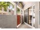 Covered patio with metal gate, sliding glass door, and textured walls, offering outdoor living space at 500 N Roosevelt Ave # 26, Chandler, AZ 85226