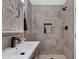 Modern bathroom features stone-look tile, a walk-in shower, and contemporary sink at 5020 E Dallas St, Mesa, AZ 85205
