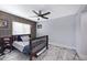 Relaxing bedroom with a wood accent wall, a ceiling fan, and a cozy bed at 5020 E Dallas St, Mesa, AZ 85205