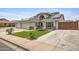 Charming home featuring a spacious three-car garage, solar panels, and low maintenance front yard at 5020 E Dallas St, Mesa, AZ 85205