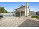 Back of house featuring a sparkling pool and large paver patio perfect for backyard barbeques at 5020 E Dallas St, Mesa, AZ 85205