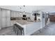 Spacious kitchen featuring an island with bar seating, stainless steel appliances, and stylish tile flooring at 5020 E Dallas St, Mesa, AZ 85205