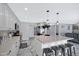 Open kitchen with center island, granite counters, pendant lighting and stainless appliances at 5020 E Dallas St, Mesa, AZ 85205